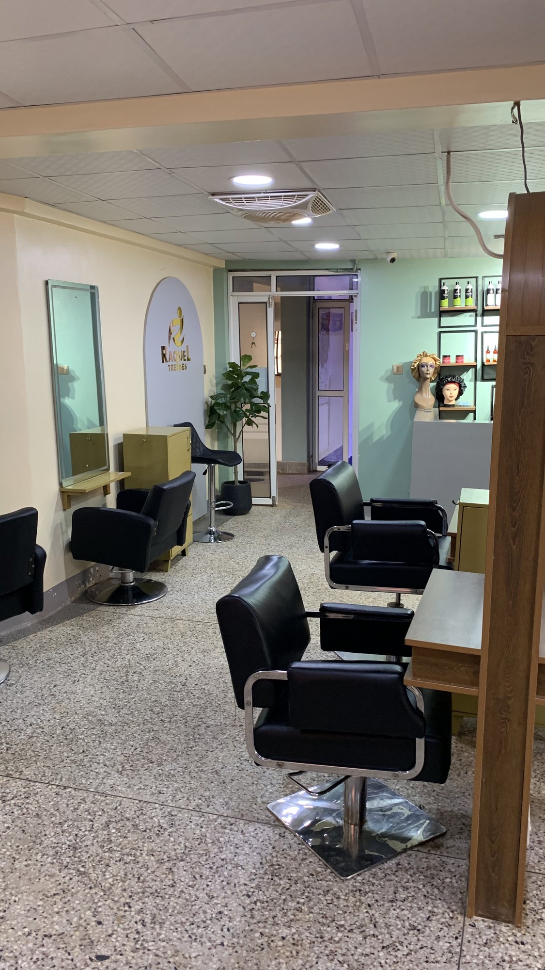 Raquel Tresses salon interior — chairs, mirrors and the product wall